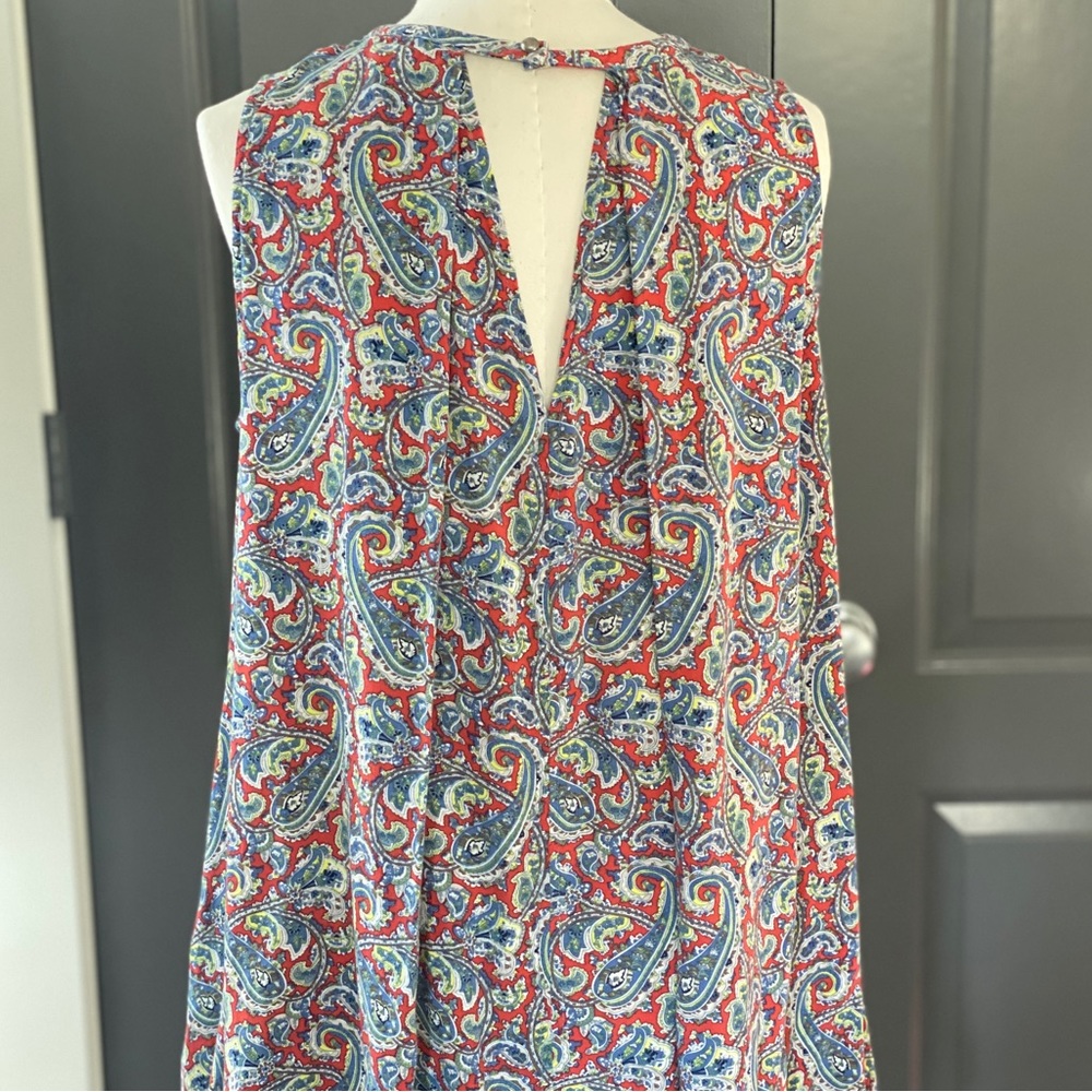 Muted red, blue and greens paisley print sleeveless top. Runs small